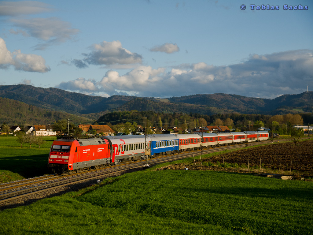 101 057 zog den D 50472 mit ersten zwei Wagen und CNL 472 mit verkehrsroten Wagen in Richtung Norden vor Kollmarsreute am 20.04.2012.