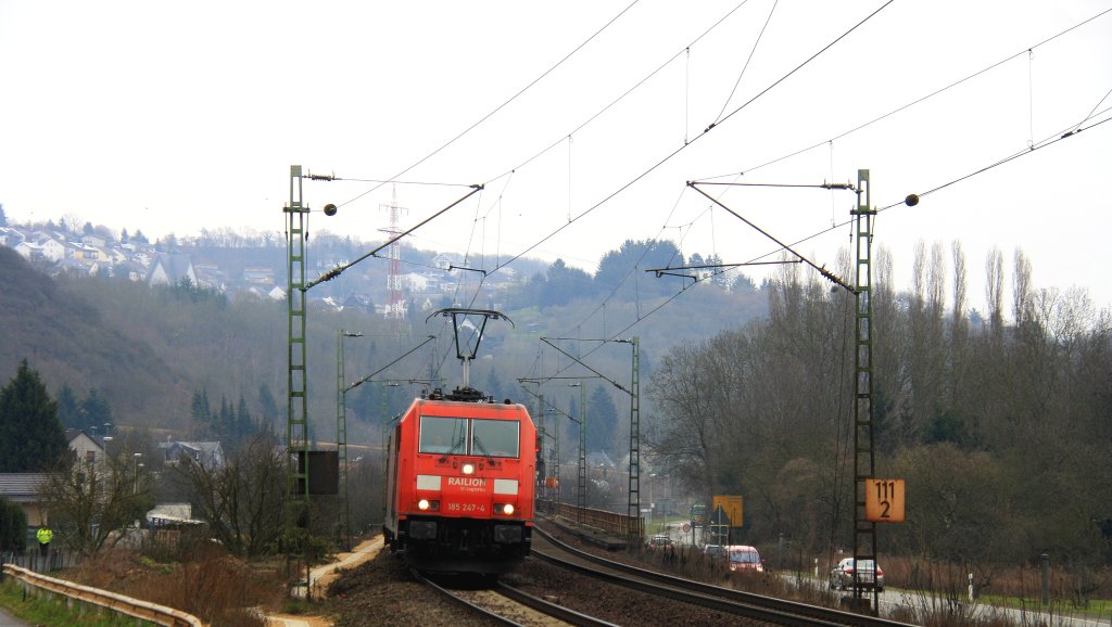 185 247-4 von Railion kommt aus Richtung Koblenz mit einem gemischten Gterzug aus Sden nach Kln-Gremberg und fhrt in Richtung Kln auf der  Rechte Rheinstrecke (KBS 465) bei Kasbach-Linz am Kalten 3.4.2013.