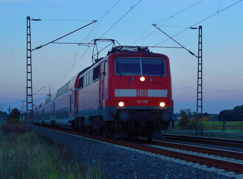 Am Bahnbergang In der Schley/am Chur kommt die 111 117 mit einer RE4 nach Aachen herangefahren am Abend des 1.10.2012 im letzten Abendlicht