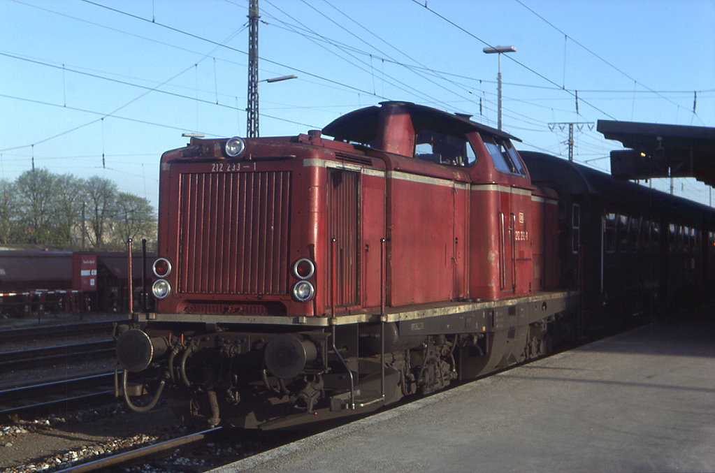 Der Inbegriff der Bundesbahnzeit schlechthin: eine V100 im alten, roten Lack. Bei solch einem Klassiker sei mal ein Lokportrait im Bahnhof gegnnt. 212 233 prsentiert sich am 27.04.1984 im Augsburger Hauptbahnhof.