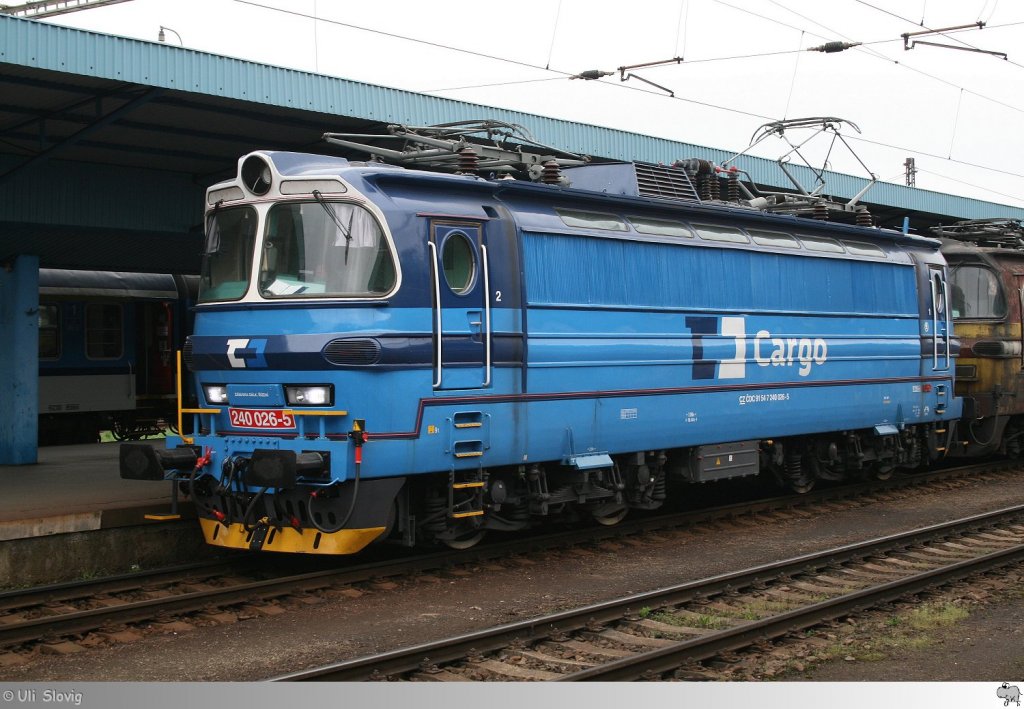 Lok # 240 026-5 der CD Cargo wartet im Bahnhof Cheb (Eger) am 1. Mai 2013 auf seine Weiterfahrt. Die Lokomotive drfte zum Zeitpunkt der Aufnahme ihr neues Farbkleid noch nicht lange getragen haben. Sie glnzte an allen Ecken und Enden, whrend die zweite Lokomotive (240 007-5) im Zugverband noch auf ihre neue Lackierung warten mu.
