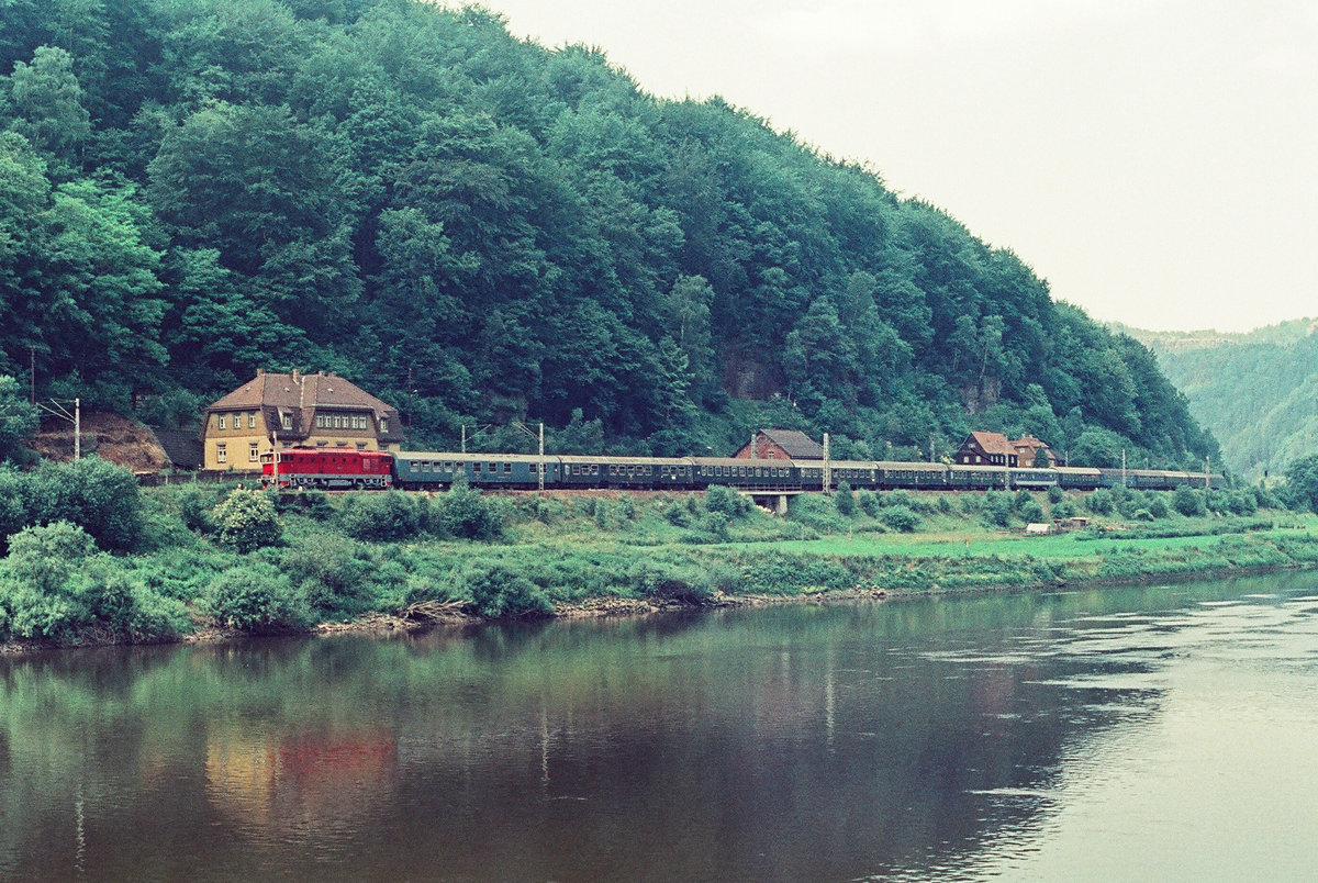 12.Juni 1983,  Am linken Ufer der Elbe befördert eine tschechische Diesellok ( Brille  BR 754) einen internationalen Schnellzug zwischen Bad Schandau und Decin.