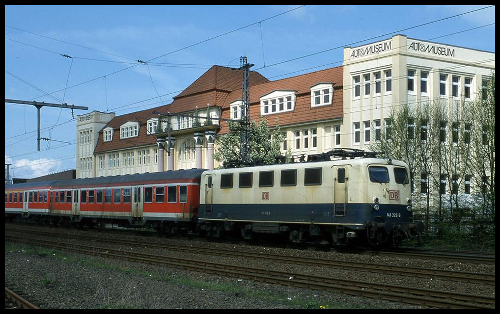 141326 erreicht hier mit einem RB aus Osnabrück kommend am 29.04.2001 um 12.04 Uhr den Bahnhof Melle. Im Hintergrund das Automuseum in Melle, welches früher mal eine Möbelfabrik war.