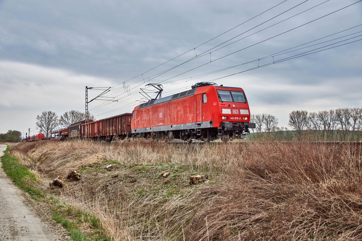 145 078-2 ist mit einen gemischten Güterzug in Richtung Süden unterwegs,gesehen am 11.04.2018 bei Friedland..