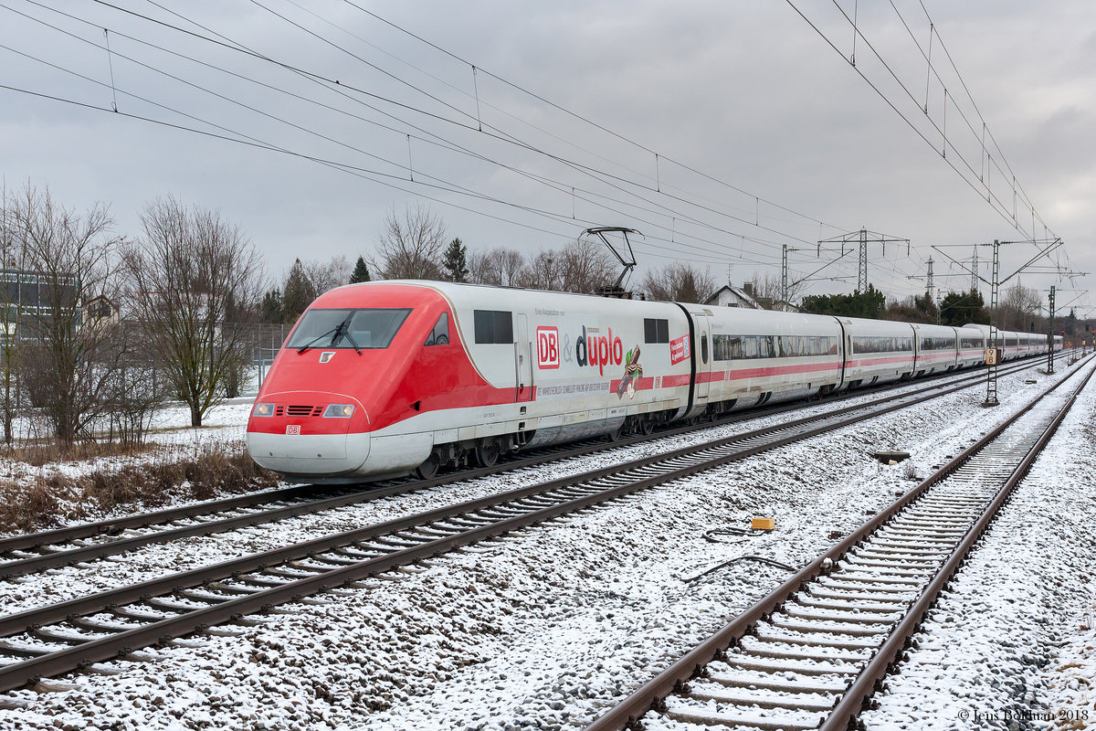 401 012 / 512 ist als ICE 596 auf dem Weg von München Hbf nach Berlin. Er trägt die noch recht frische Beklebung des Werbepartners Ferrero und wird daher als  Duplo-ICE  bezeichnet. Hier bei der Durchfahrt durch München-Langwied am 21.01.2018