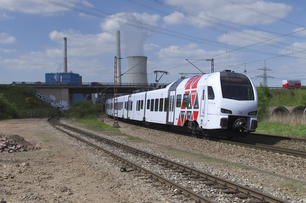429 122 ist als RE Trier - Mannheim unterwegs. Die Triebzug hat gerade das Kraftwerk Ensdorf passiert und fährt nun am Gelände des ehemaligen Brückenaußenlagers Karthaus in Bous vorbei. Bahnstrecke 3230 Saarbrücken - Karthaus am 09.05.2017