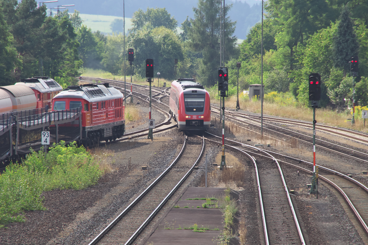 612 169 erreicht als RE Nürnberg - Hof gerade den Bahnknoten Kirchenlaibach. Links stehen 232 703-9 und 233 636-0 mit ihren Güterzügen. 21.08.2015