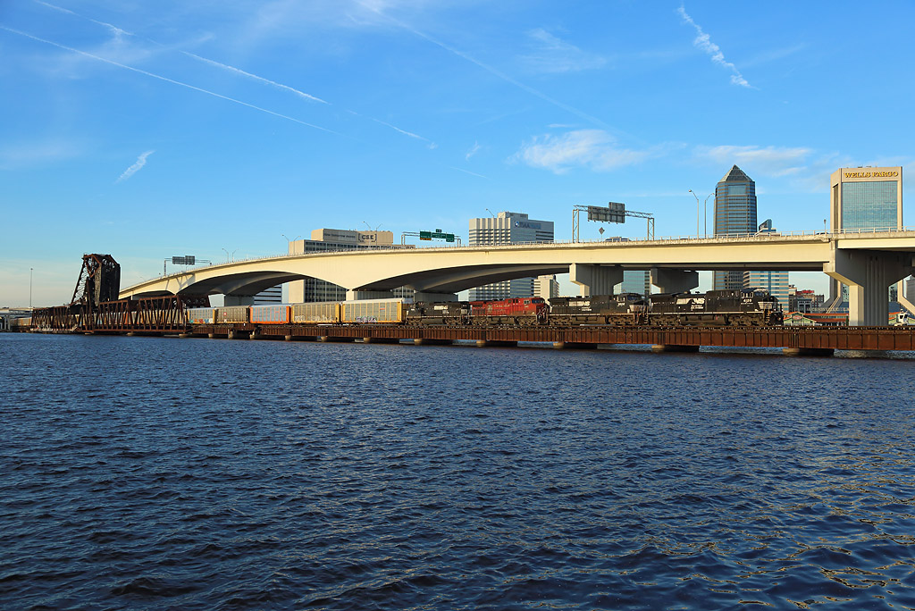 A Norfolk Southern train crosses the St Johns River in Jacksonville with a freight train bound for the Florida East Coast Railway`s Bowden Yard. Freom here the train will continue south with FEC traction, 28 Nov 2018.

The locomotives are 4120, 9502, 8501 & 9150