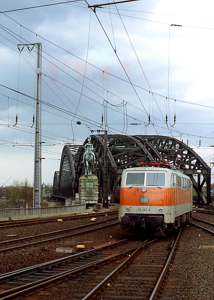 Als 111 121-0 Anfang der 1980er Jahre mit einem Nahverkehrszug in den Kölner Hauptbahnhof einfährt, ist die Hohenzollernbrücke noch viergleisig