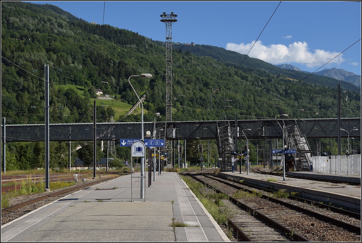 Bourg-Saint-Maurice, Dorf mit TGV und Eurostar-Anschluss aus London, Paris, Amsterdam, Brüssel und Lyon. Allerdings nur im Winter. 

Im Sommer sind die Bahnsteige wesentlich überdimensioniert. Ein Gleis ermöglicht sogar eine Zugangskontrolle und ist vollständig umzäunt. Die zwanzig Gleise sind zu diesem Zeitpunkt praktisch verlassen. Wenn man genau hinschaut, so sieht man die Gleistrasse des Funiculaire Arc 1600. Juli 2017.