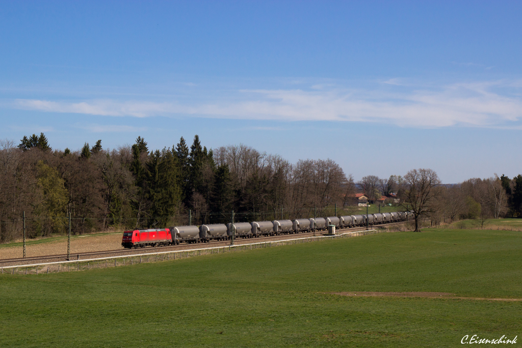 DB 185 217 bespannte am 30.03.14 einen umgeleiteten Silowagen Ganzzug von Salzburg in Richtung München. Gerade hat der Zug Übersee passiert und wird in wenigen Minuten Bernau erreichen.