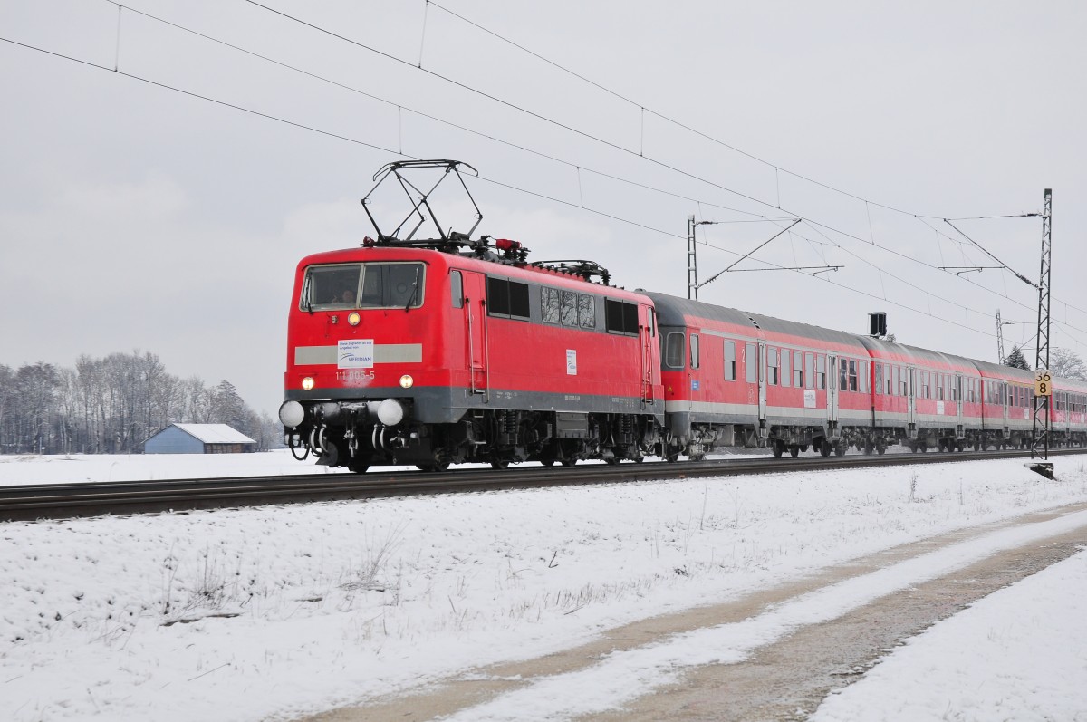 Die 111 005-5 der DB vor dem Regionalzug Salzburg- München am 25.01.14 bei Übersee am Chiemsee zur Verstärkung der Meridian Züge, wie man auf den überklebten DB Logos erkennen kann.