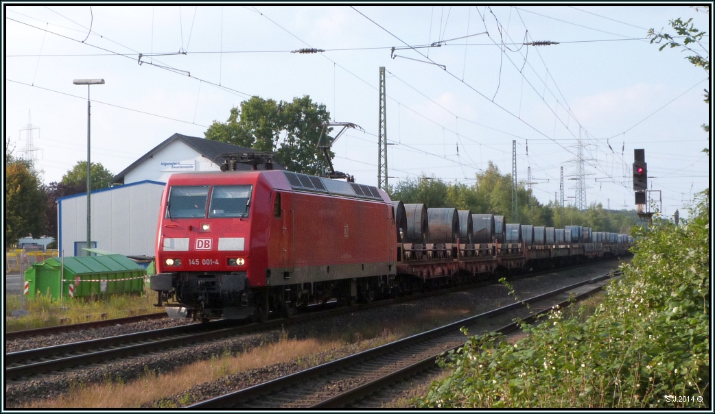 Die 145 001-4 befördert einen langen Coilzug in Richtung Düsseldorf. Hier zu sehen bei der Durchfahrt in Ratingen-Lintorf Ende September 2014.