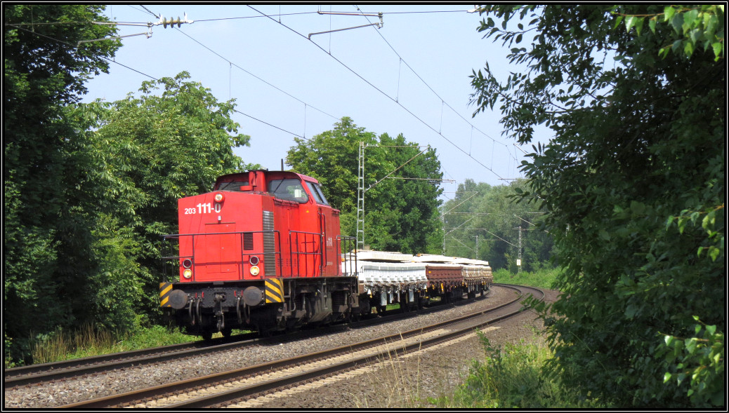 Die 203 111-0 ist mit Gleisbaumaterial auf der Kbs 485 unterwegs nach Aachen. Hier zu sehen bei Rimburg am 16.Juli 2015.
