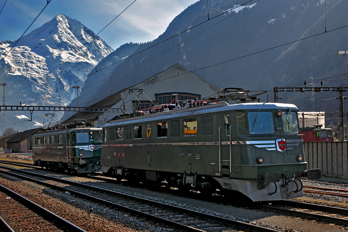 Die Ae 6/6 11411  Zug  zusammen mit der Ae 6/6 11402  Uri  vor dem Lokschuppen in Erstfeld.Bild vom 7.3.2015