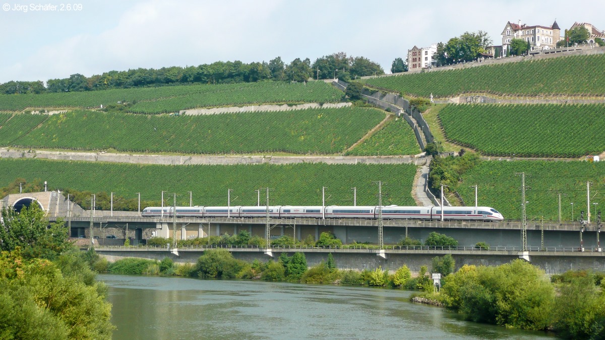 Ein ICE-3 verließ am 2.6.09 den Steinbergtunnel und rollte auf den Würzburger Hbf (rechts vom Bildrand) zu. Im Vordergrund floss der Main ruhig dahin.