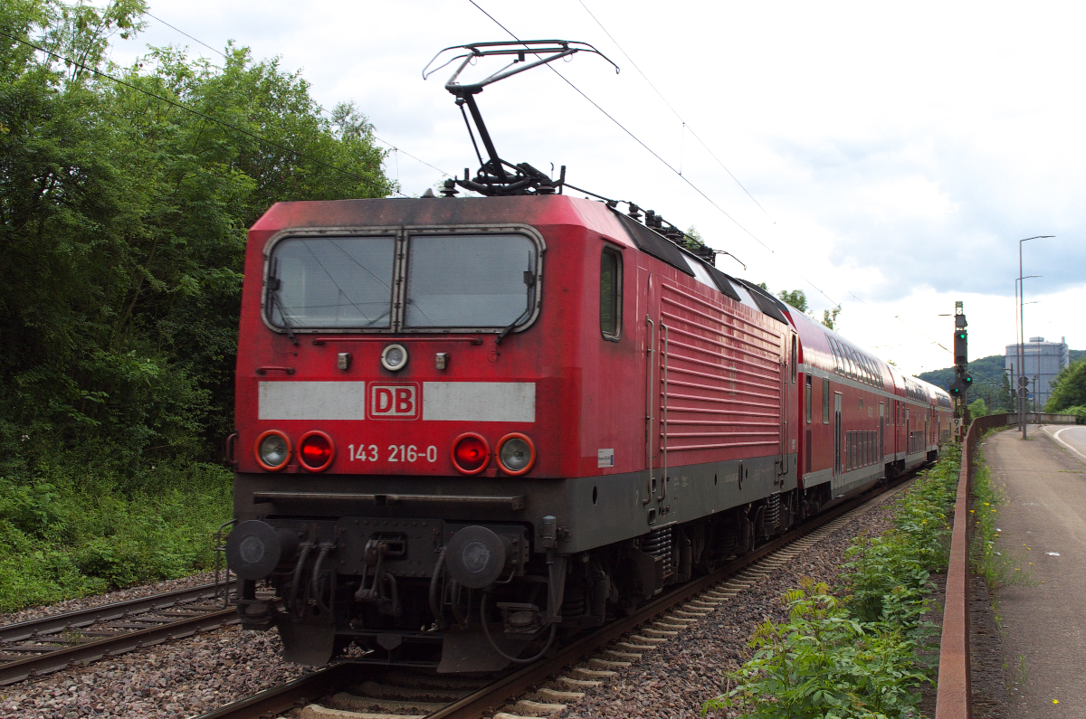 Ein wenig fehlen uns schon die 143er im Saarland. Im Jahr 2013 waren sie aber noch auf der Saarstrecke vertreten. 143 216 schiebt ihren RE von Saarbrücken nach Koblenz und hat gleich den Bahnhof Völklingen erreicht. Bahnstrecke 3230 Saarbrücken - Karthaus am 04.07.2013