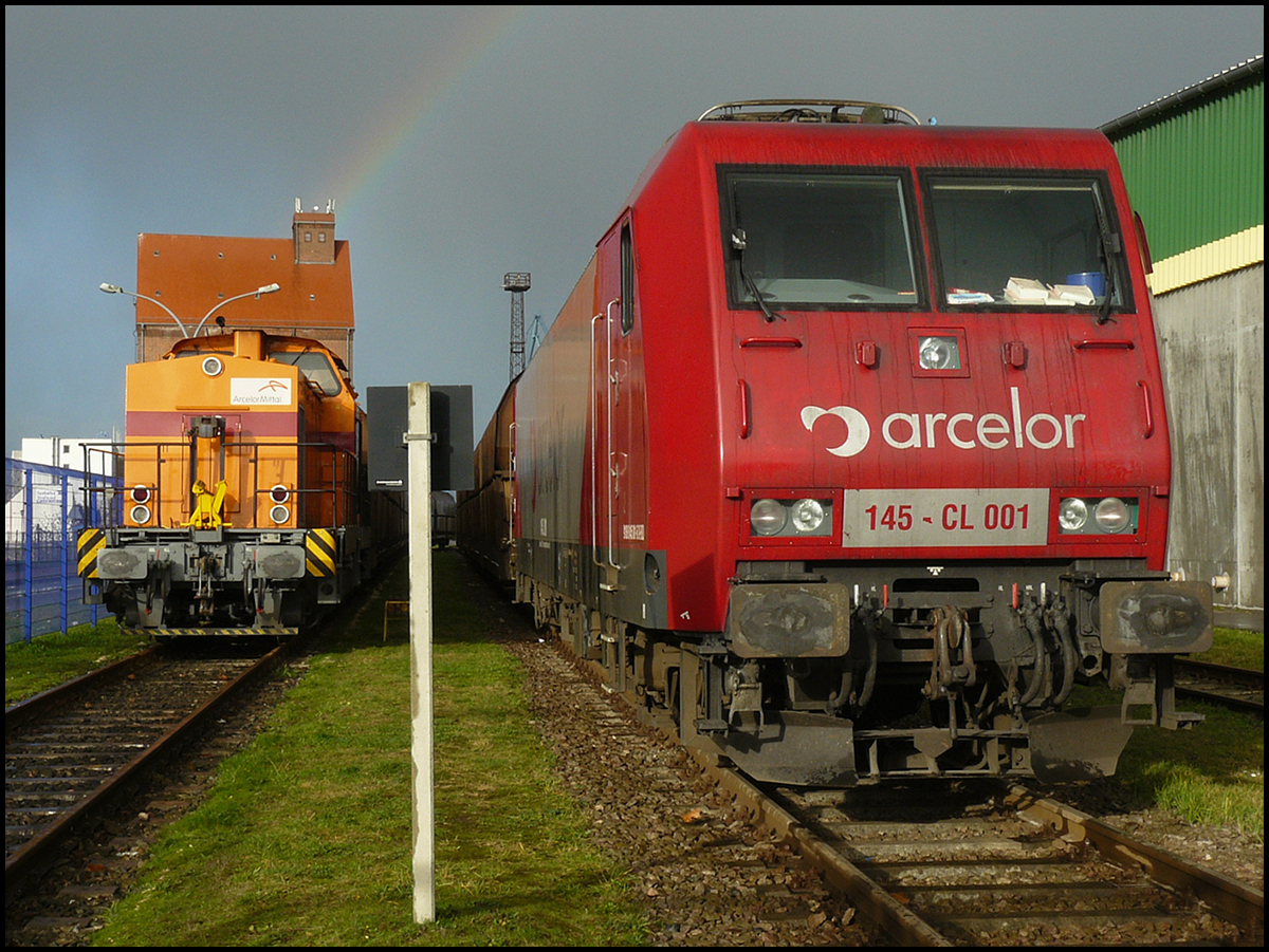 EKO 145-CL001 und eine V100 von AEH ruhen sich am 20.11.2008 im Stralsunder Nordhafen unterm Regenbogen aus.

Das Foto entstand durch das geschlossene Hafentor.