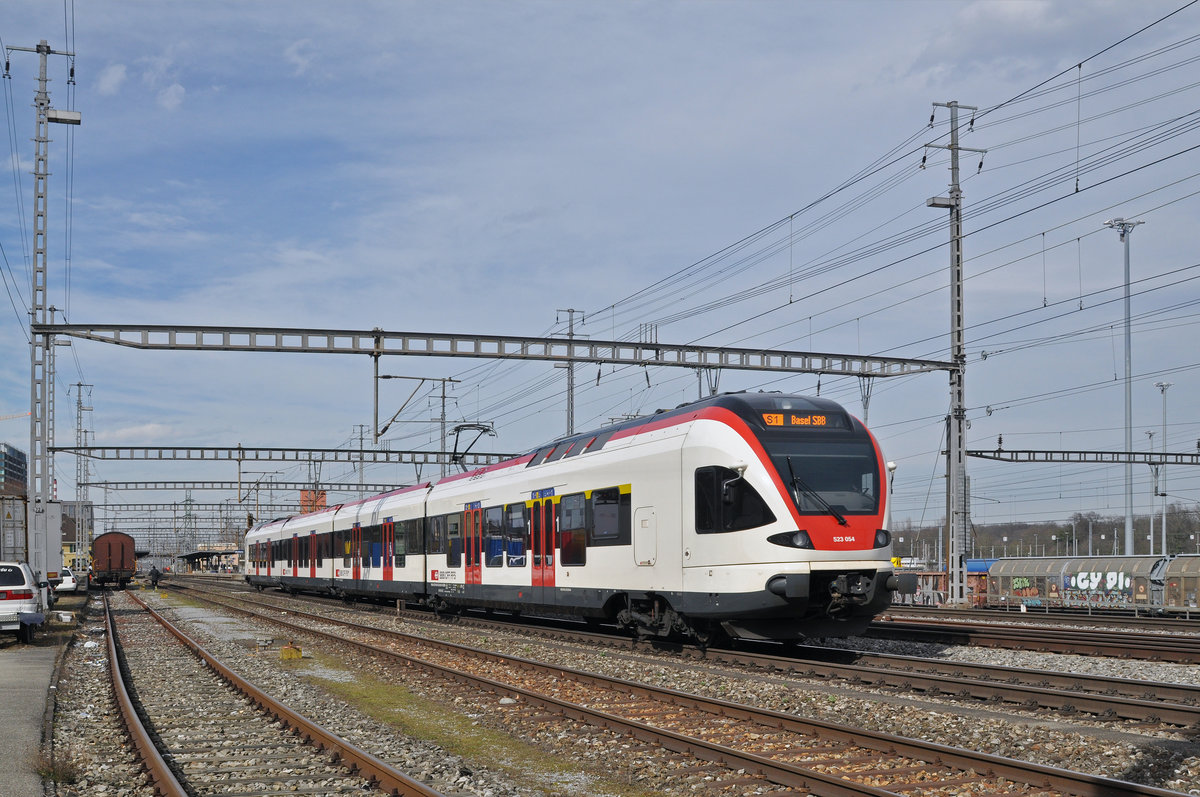 RABe 523 054, auf der S1, fährt zum Bahnhof Muttenz. Die Aufnahme stammt vom 04.03.2017.