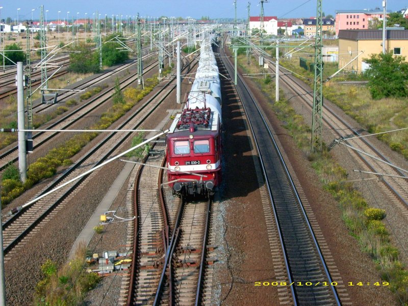 211 030 of PEG on 10/10/08 with a freight train