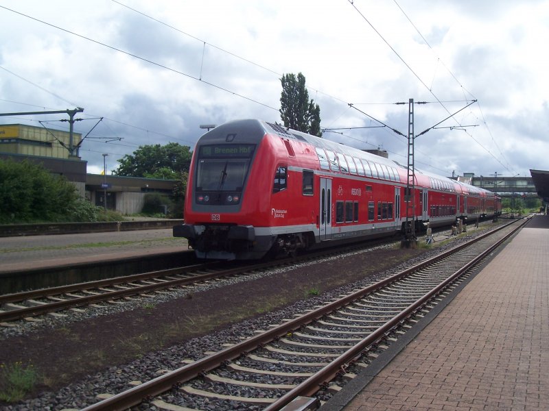 A back shot of a RE control cars by train