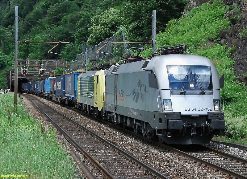 Hupac ES64U2 102 + NordCargo E189 993NC leading a southbound freight train near Biasca on the 14th of June in 2008