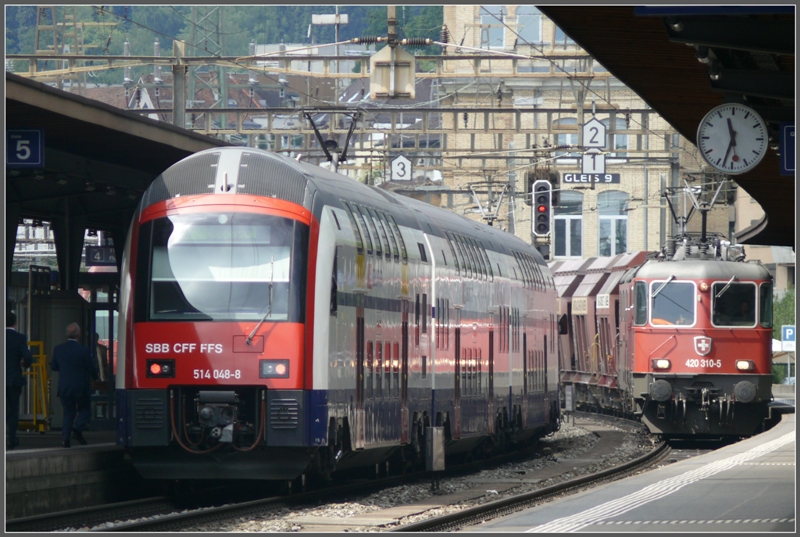 W�hrend 514 048-8 in Oerlikon h�lt donnert ein Kieszug mit