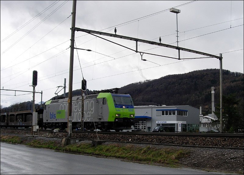 A BLS Re 485 by driving a freight train from