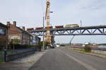 Infrabel-Lok 6274 schiebt den Schotterzug in Schritttempo über die neue Maasbrücke in Visé. Aufnahme vom 21/09/2017.