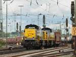 7771 und 7775 zerren am 08.07.2011 in Aachen West an einem langen Autozug, den sie ber die Rampe der Montzenroute nach Belgien bringen.