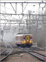 Die AM65 228.256 verlsst am 27.02.09 den Bahnhof von Brugge mit den Spitzenlichtern am Ende des Zuges.