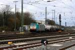 Die Cobra 2822 fährt mit einem langen Kesselzug aus Ludwigshafen-BASF nach Antwerpen-BASF(B) bei der Ausfahrt aus Aachen-West und fährt in Richtung Montzen/Belgien bei Sonne und Regenwolken