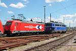 Am 20.07.2015 stand RheinCargo 2053 (185 585-7) abgestellt neben der WRS Ae 1042 007 (ex. ÖBB) im nördlichen Vorfeld von Basel Bad Bf und warten zusammen auf deren nächsten Einsatz.