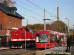 Die V 100 ( 112 708-3 ) hat Begegnung mit der Straenbahn 411 der City-Bahn Chemnitz in Neukirchen-Klaffenbach am 31.10.2009