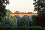 216 021 überquert mit der morgendlichen Übergabe nach Heiligenhaus die Velberter Saubrücke, 29.08.1985.