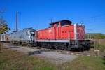 Im Anschluss des Bahnhofs Anklam E- & Diesellok mit beladenem Holzwagen.