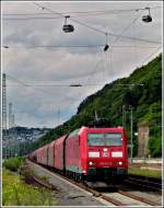 - An Mosel und Rhein - Die 185 112-0 zieht am 24.06.2011 einen Gterzug durch den Bahnhof Koblenz-Ehrenbreitstein, whrend oben die Rheinseilbahn unermdlich die BuGa Besucher transportiert. (Jeanny)
