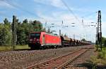 Durchfahrt am 06.06.2014 von 185 403-3  Green Cargo  mit einem Schotterzug aus Richtung Süden in Orschweier.