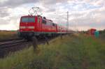 Mit einer Fuhre RE7 bestehend aus N-Wagen schiebt die 111 122 bei Allerheiligen in Richtung Krefeld vorbei. 3.8.2012