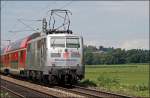 111 027 schiebt den RE 30028  Mnchen-Salzburg-Express  bei Bernau am Chiemsee in die Bayerische Landeshauptstadt. (09.07.2008)