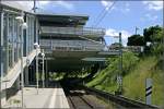 S-Bahn-Station  Echterdingen : Blick in Richtung Flughafen mit der Parkhaus-berbauung. Im weiteren Verlauf der Strecke wird ein kurzer 100 Meter langer Tunnel durchfahren, der schon 1975 beim Bau einer Schnellstrae als Vorratsbau miterrichtet wurde, aber bis zum Bau der S-Bahnstrecke 1987 ungenutzt im Boden lag. Der Tunnel wurde wieder  ausgegraben  und zunchst als Abtransportstrecke fr die Erdarbeiten der Einschnittstrecke in diesem Bereich genutzt. 24.6.2007 (Matthias)