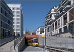 In der Häuserschlucht -    Ein Zug der Linie U12 erreicht im Stuttgart Europaviertel neben einer neuen Straßenbahnhaltestelle das Tageslicht.