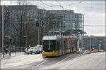 Der Hauptbahnhof im Hintergrund -    Eine Straßenbahn vom Typ Flexity Berlin hat die Haltestelle Hauptbahnhof verlassen und fährt durch die Invalidenstraße in Richtung Spandauer