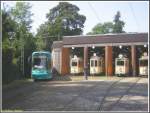 Der S-Triebwagen 250 am 12.08.2007 auf dem 7. Zug der Linie 12 bei der Ausfahrt aus der Wendeschleife der Endhaltestelle Schwanheim/Rheinlandstrae, die das Gebude der Halle West des Verkehrsmuseums umrundet. In den geffneten Toren des Museums von links nach rechts der H-Triebwagen 510 (Baujahr 1939 Westwaggon) F-Triebwagen 411 (Baujahr 1925 Waggonfabrik Uerdingen) D-Triebwagen 392 (Baujahr 1914 Gastell) und der R-Triebwagen 15 der ehemaligen Stdtischen Straenbahn Offenbach, 1908 in der Waggonfabrik Werdau gebaut.