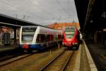 Usedomer Bäderbahn und ein moderner Flirt, 429026 der DB, treffen sich am 13.02.2014 um 10.59 Uhr im Bahnhof Stralsund.