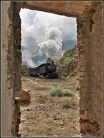Eritrean Railways steamtrain special fährt in Lessa ein, dessen Bahnhofgebäude weitab von jeder Siedlung nur noch eine Ruine ist.