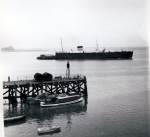 Die Train Ferry (Fhrschiff) Harwich - Zeebrugge fhrt ab in Richtung Kontinent, beladen mit zahlreichen und auf dem hinteren Deck teilweise sichtbaren Gterwagen. Harwich, 15.Juli 1964.