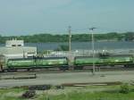 Guterwagen Burlington Northern tank cars. These cars were once used for testing purposes (early 1980s) when the railroad was testing propane as fuel. I worked at Caterpillar Engine Division at the time, and several of these tank cars would be attached to a group of locomotives for long range fuel efficiency testing runs from Wyoming to Chicago and beyond. I quit Cat in 1984 and the program was cancelled shortly thereafter. Illinois side of train bridge across Mississippi River seen at right.