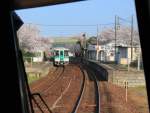 Lokalverkehr auf Shikoku - der Nordosten: Bei der Durchfahrt im Intercity-Zug durch Zôda auf der Hauptstrecke zwischen den beiden Städten Takamatsu und Tokushima wird ein Zweiwagen-Lokalzug überholt. Komposition aus Serie 1500 und Serie 1200 Nr.1232. 2.April 2015. (Aufnahme durch die verglaste Rückwand zum Führerstand) 