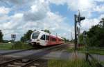 Der Flirt Triebwagen der Arriva-Bahn fuhr am 30.06.2012 von Leer nach Groningen, hier sdlich von Leer.